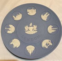 Plate depicting 8 famous London landmarks in white relief on pale blue Jasperware with central London coat of arms