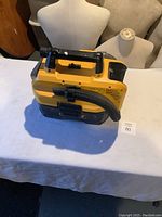 View of the DeWalt shop vacuum from the side showing handle and hose attachment