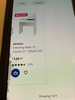 Photo of IKEA website listing showing BRIMNES dressing table with price and dimensions.