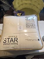 Photo showing the front of the packaged duvet with the brand, thread count and size details.