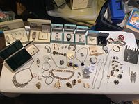 Overview of table with jewelry boxes and loose jewelry items