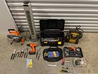 Overview of all mixed tools including power drill, hand tools, toolbox, and tower fan