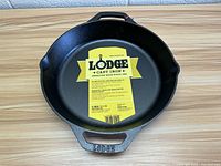 Front view of the 12 inch Lodge cast iron pan with brand label inside.