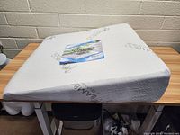 Side angled view of the bamboo foam wedge pillow showing the gradual incline and fabric texture.