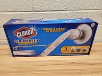 Front view of the Clorox Scrubtastic Power Scrubber box showing product and three included brush heads.