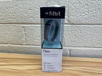 Front view of Fitbit Flex wristband in original packaging showing brand, model and features.