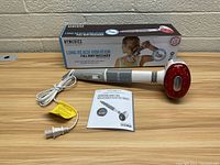 Full view of Homedics Long Reach Vibration Full Body Massager with power cord, user manual, and original box behind.