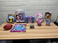 Full view of the lot on wooden table against a light gray brick wall, showing all items arranged in a line