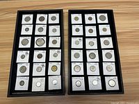 Full display of 30 foreign coins mounted in white holders with clear handwritten annotations.