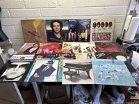 Photo showing the collection of vinyl record albums spread on a table with visible covers from various artists including Herb Alpert, ABBA, Bruce Springsteen, and Bob Seger.