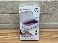 Front view of the PureMobile UV sterilizer box showing the device and branding.