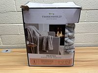 Front view of Threshold box showing image of beige/grey heated faux fur throw blanket on chair, with visible product details and branding.