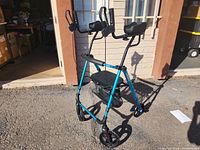 Full front and side view of blue rollator walker with seat and basket