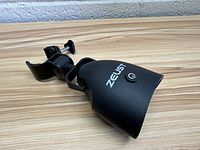 Front side view showing the clamp mount and Zeust branding on the grill light.