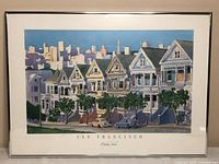 Full view of the framed and matted watercolor print depicting the Painted Ladies of San Francisco with cityscape background.