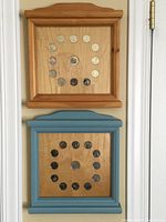 Two framed Canadian coin sets from 1999 and 2000 arranged in circular patterns on wooden backings within wooden frames, one natural finish and one blue painted, each approximately 12x11 inches.