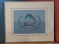 Full view of framed "Serenity" print showing silver metal frame and double matting around the print with light blue and cream colors.