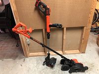 Photo of Black & Decker electric edger and whipper snipper showing full tools, orange and black color.