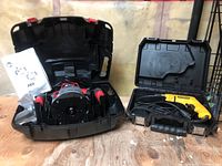 Black hard case opened showing red and black SKIL electric router with power cord and manual.