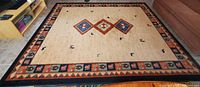 Full view of large area rug showing overall pattern and border design.
