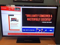 Front view of Toshiba TV powered on showing image from Rogers TV package screen.