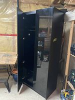 Wardrobe exterior showing black lacquered door, tall and rectangular shape.