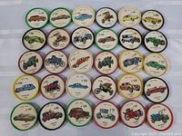 Photo of the top 15 vintage car coins/discs with colorful rims and detailed vintage car illustrations