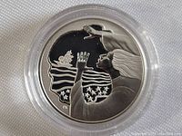 Reverse side of the coin showing artistic design of woman reaching towards a ship and stars, signature 'PK' present, silver finish, in protective capsule.