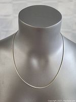 Front view of the sterling silver necklace on a display bust showing its length and fit.