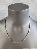 Front view of the sterling silver braided necklace on a mannequin showing chain design and length.