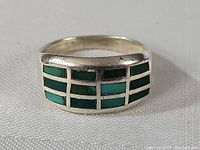 Top view of the sterling silver ring showing rectangular green segmented inlay pattern.
