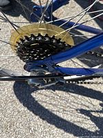 Close-up photo of the rear wheel showing the multi-speed gear cassette and chain.