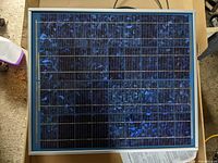 Front view of the BP solar panel with visible blue-black solar cells and metallic frame.