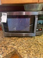 Front view of Toshiba solo microwave oven showing stainless steel exterior, digital control panel on right, and countertop placement.