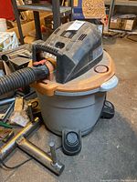 Ridgid shop vac wet/dry vacuum, side view showing hose, motor housing and tank.