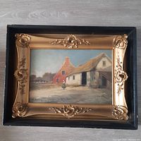 Full view of the antique oil painting showing pastoral farm scene, gold ornate inner frame and black outer shadowbox frame.