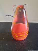 Front view of the Caithness Glass paperweight showing the cat-shaped design with pink and yellow internal coloration.