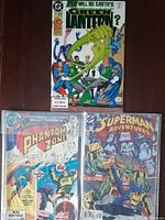 Three vintage DC comics shown together; Green Lantern, Phantom Zone, Superman Adventures.