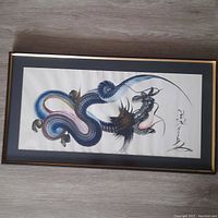Full view of the framed vintage Japanese dragon painting showing the entire dragon and signature.