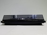 Side view of the JVC AL-F350 turntable with closed dust cover displaying the unit's profile and JVC logo.
