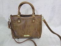 Front view of brown Steve Madden vegan leather handbag with double handles and removable shoulder strap.