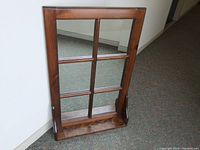 Full view of rustic wooden window pane mirror upright showing six mirror sections and bottom ledge shelf