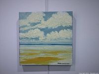 Front view of one seascape oil painting showing textured clouds and sea with yellows and blues, signed by artist on bottom right.