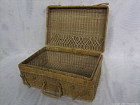 Front open view of the wicker suitcase showing the interior wicker weave and interior pocket.