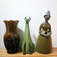 Front view of three items showing the vase, cat figurine, and woman figurine.
