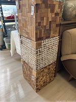 Stacked view of three wooden cube side tables highlighting wood grain and block patterns with protective cardboard corners.