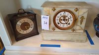 Wood case Elgin clock and marble case Ansonia clock side by side on shelf