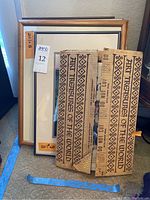 Five framed art pieces stacked together showing metal and wood frames with labels for sizes 13x18 and 8x11.