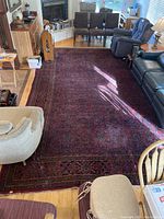 Full view of large rectangular rug in room with furniture