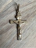 Front of the small 10k gold crucifix pendant showing detailed Jesus figure and INRI plaque on a flat cross base.